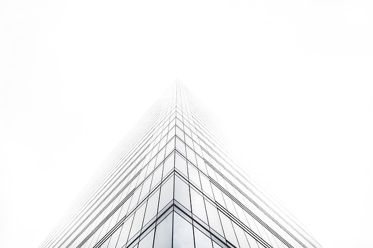 low angle photography of skyscraper under cloudy sky during daytime