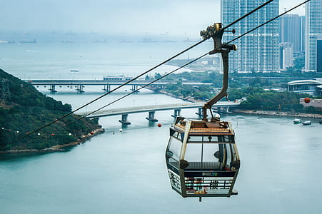 brown and gray cable car above sea