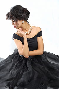 woman wearing black off-shoulder dress