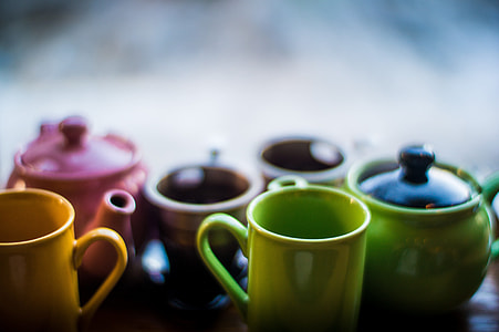 assorted-color ceramic teapots and cups