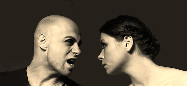 man and woman on grayscale photography
