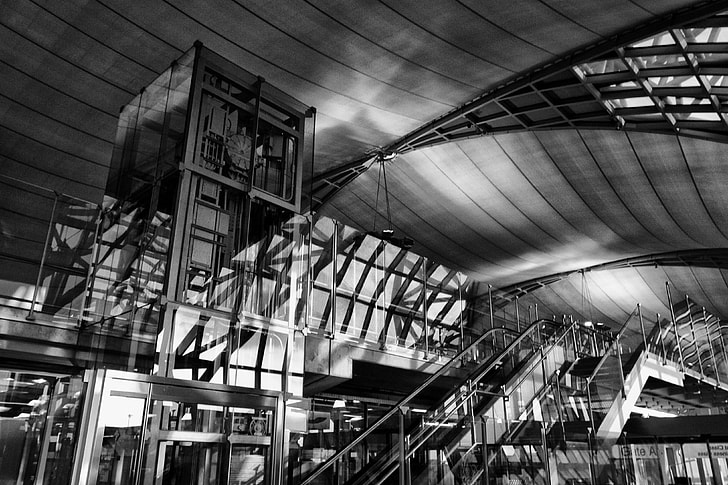 Black and white image captured inside the stunning architecture of the Bangkok Airport, Thailand. The Thai name for the airport is ‘Suvarnabhumi’