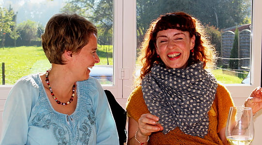 two laughing women in well lit room