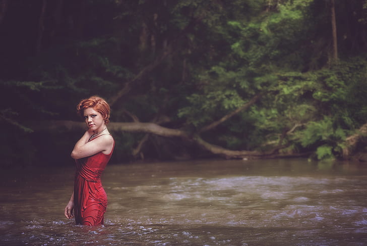 woman in body of water wearing red dress