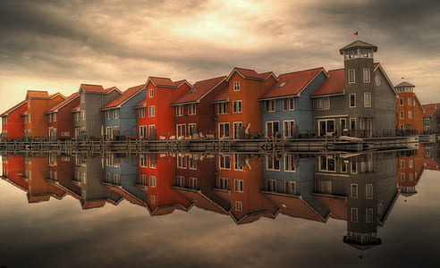 red and blue house near water photography