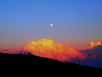 silhouette of hill near smoke under full moon