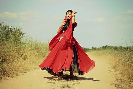 woman wearing black and red short-sleeved long dress with headdress