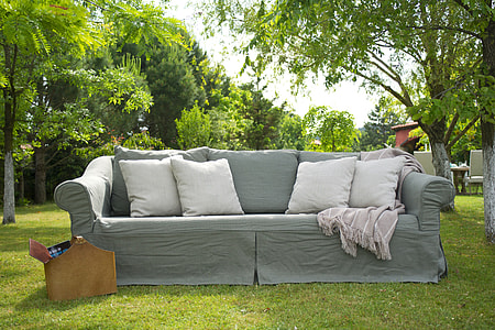 grey sofa with four white throw pillows