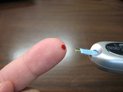 person checking a blood sugar