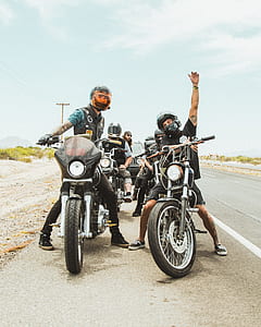 group of people riding motorcycle in front of black Jeep SUV