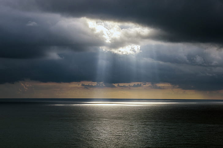 photo of ocean with crepuscular rays