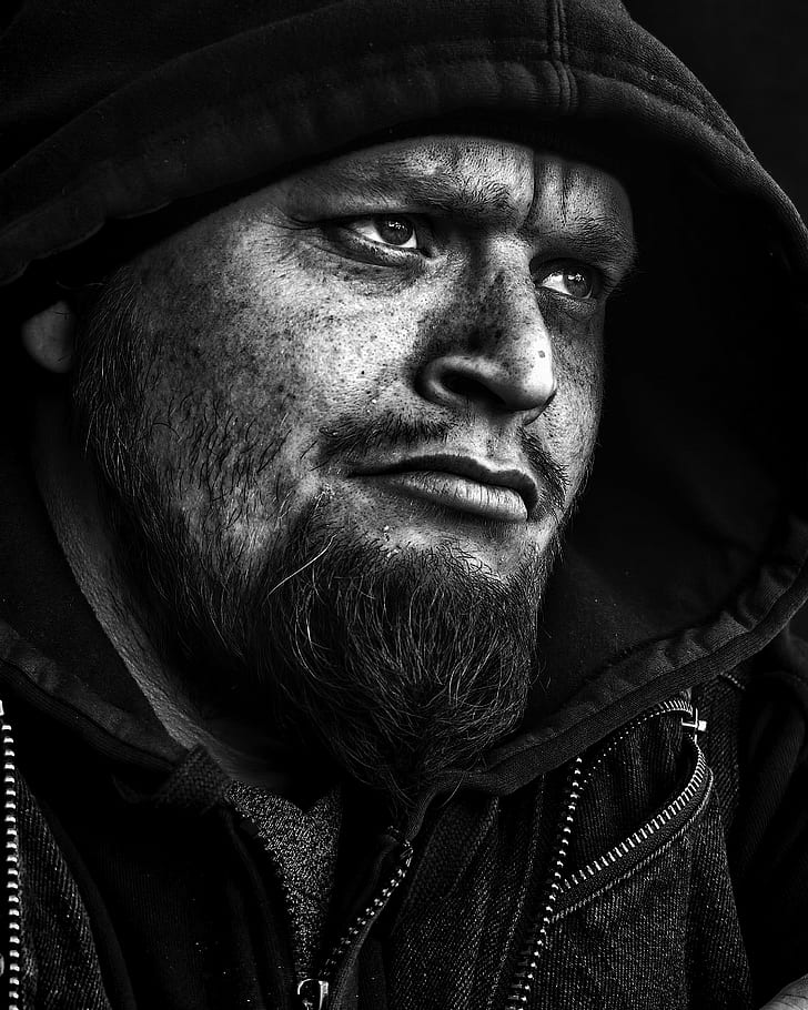 black and white photo of man with hooded jacket