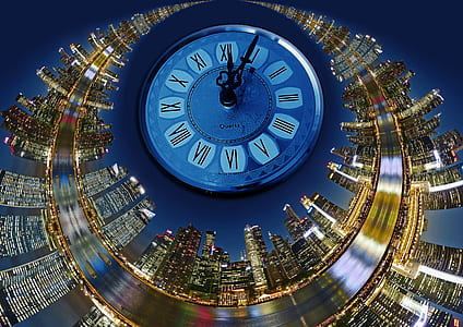 closeup photo of analog clock at 12:05 with high rise tower