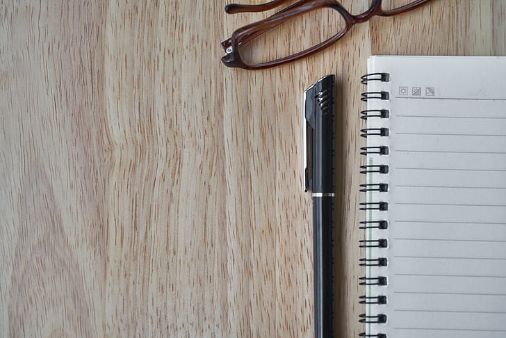 notebook beside a pen and eyeglasses wallpaper