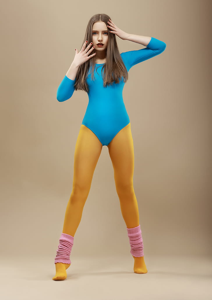woman wearing blue long-sleeved bodysuit and yellow tights