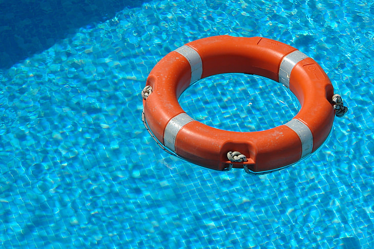 red and gray inflatable ring on pool
