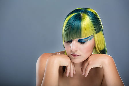 topless woman with green and yellow hair posing