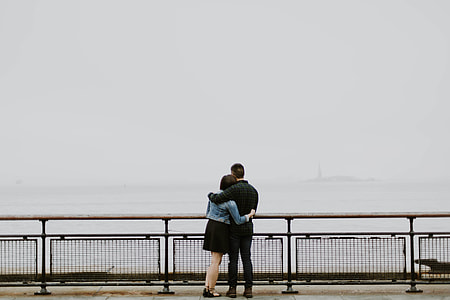 man and woman hugging near on black frame