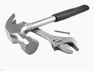 black and gray claw hammer and gray adjustable wrench