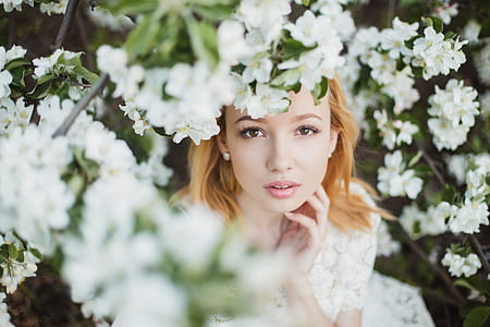 woman surrounded by white flowers photograph