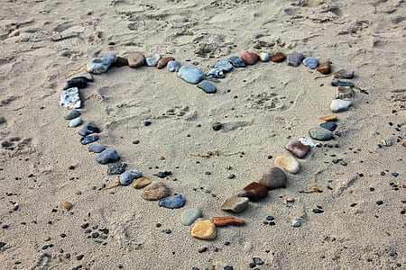 heart shaped stone in the sand