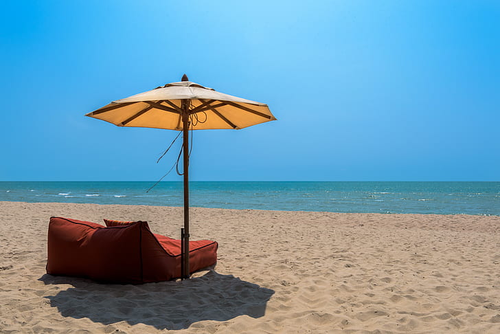 umbrella with lounge chair near beach
