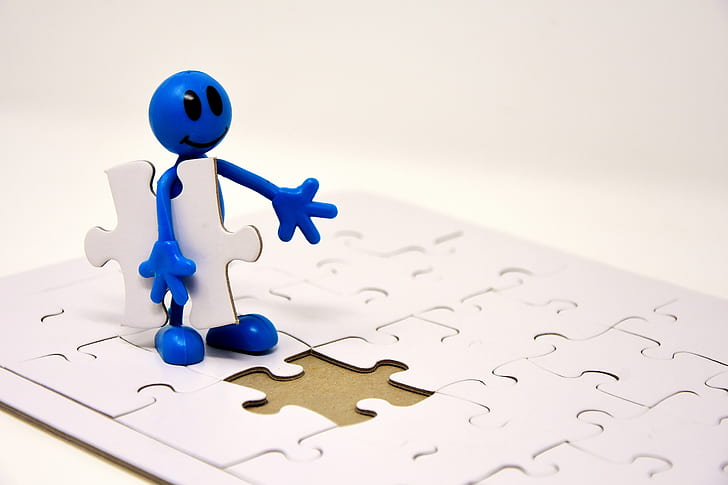 blue character holding jigsaw puzzle