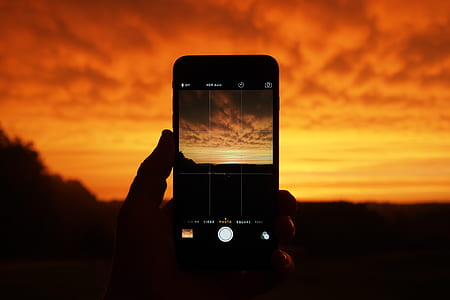 silhouette photo of orange sky during golden hour