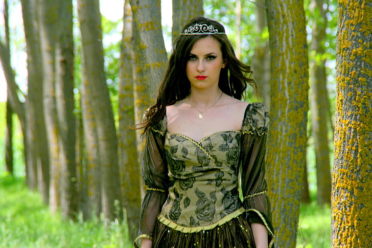 woman wearing medieval dress standing beside tree