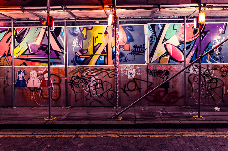 Street art and graffiti by building scaffold in Shoreditch, East London