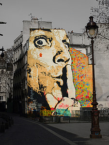 selective color photography of man's face graffiti