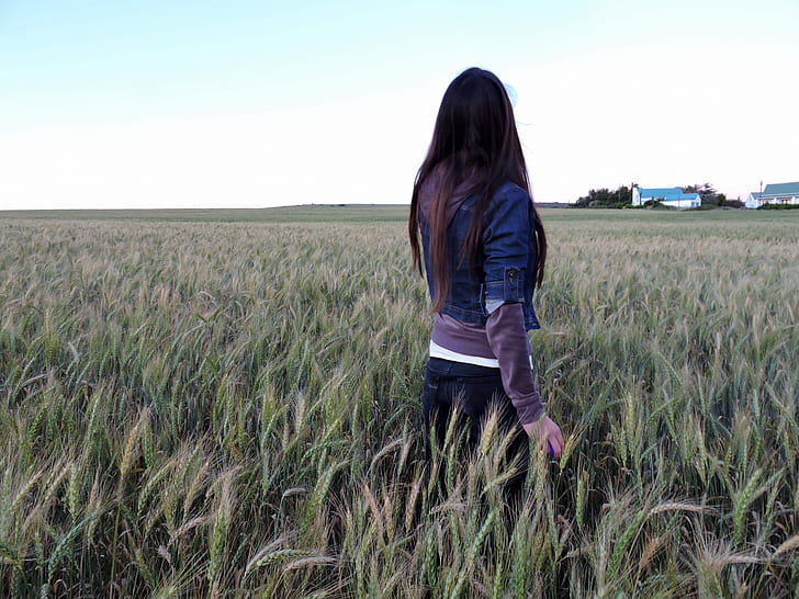 woman standing on green farm field