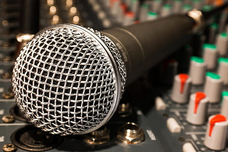 black and gray corded microphone on audio mixer