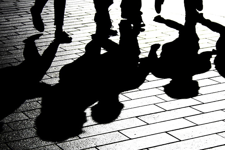 silhouette of group of people on brick floor