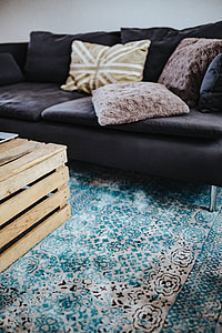 Designer living room interior with a wooden box table and a light blue carpet