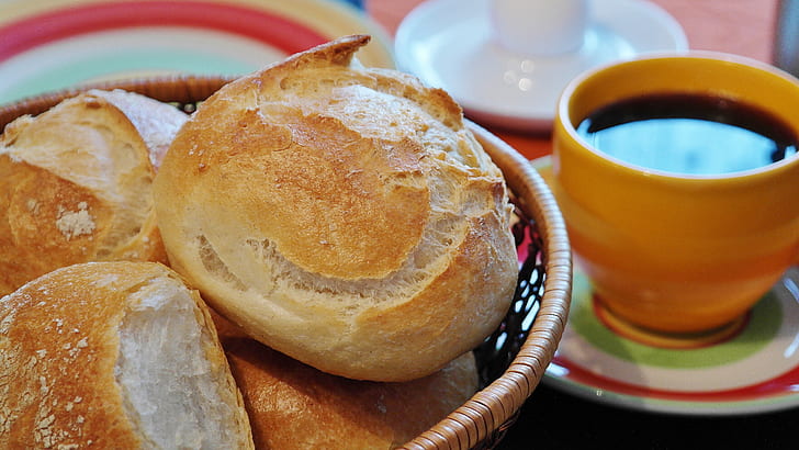 bread on bowl beside cup of cuffee