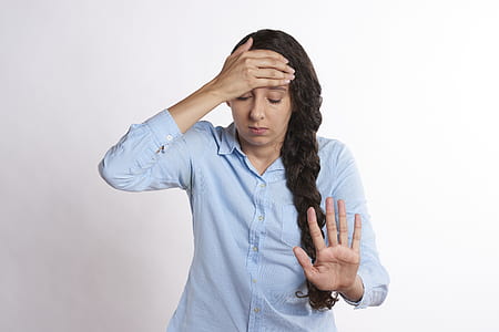 woman wearing blue dress shirt stopping gesture