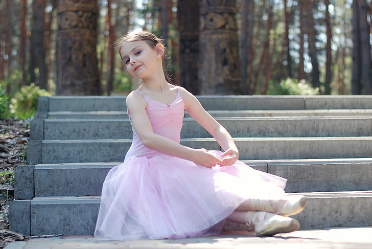 girl wearing a pink ballerina suit