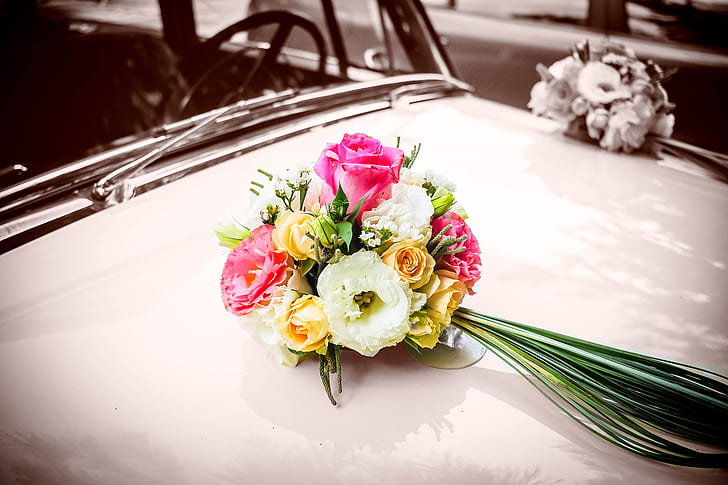 white, yellow and pink rose bouquet on car