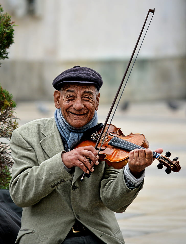 man using violin smiling