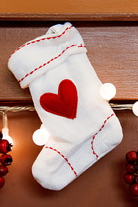 hanged white and red heart-embroidered Christmas stocking