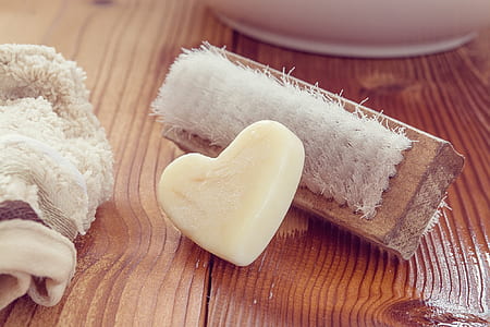 white heart soap near brown brush