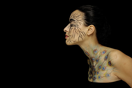 photo of woman with face and body tattoo