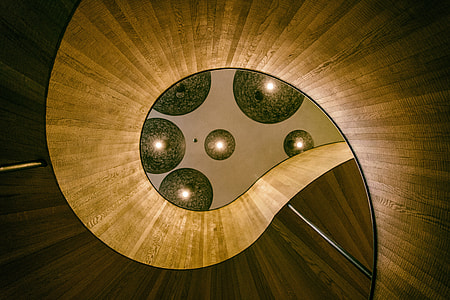 Lights above a spiral staircase in a designer hotel in London, England