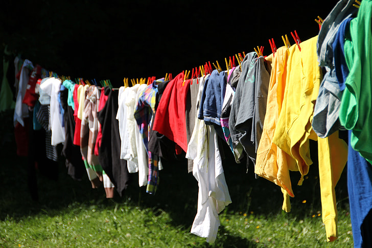 assorted-color clothes hang on drying rack