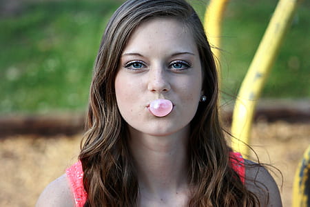 woman blowing bubblegum