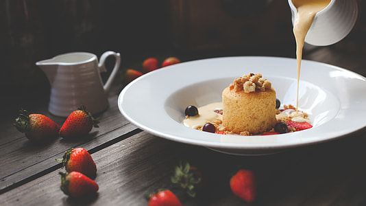 white ceramic plate with cake and strawberries