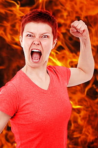woman in red v-neck top with flame background