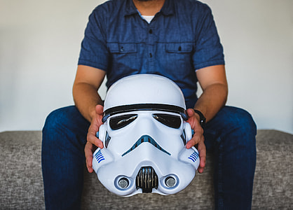 man holding Star Wars Stromtrooper helmet