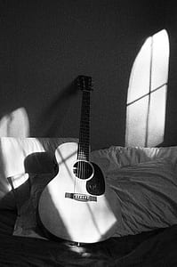 White Acoustic Guitar on Grey and White Textile